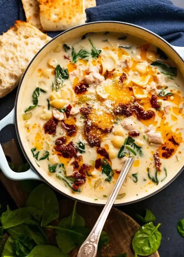 Bowl of Heavenly Creamy Tuscan Chicken Soup garnished with fresh herbs