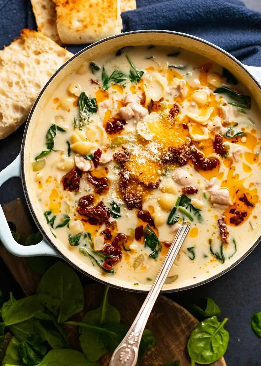 Bowl of Heavenly Creamy Tuscan Chicken Soup garnished with fresh herbs